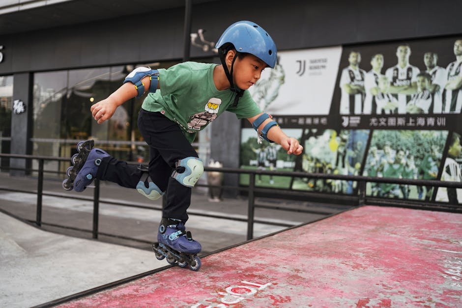 A boy performing a move on roller skates at a skatepark, wearing protective gear.