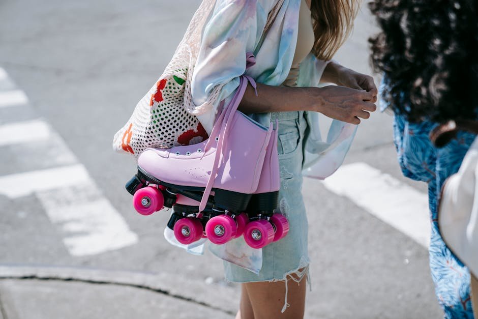 Woman with pink roller skates and mesh bag enjoying a sunny day outdoors.