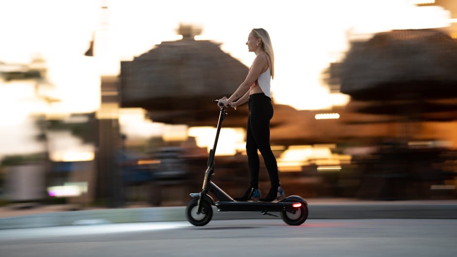 Woman enjoying an evening ride on an electric scooter with motion blur capturing speed and excitement.